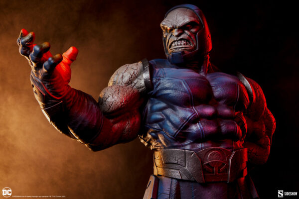 Darkseid DC Comics Maquette from Sideshow Collectibles. Close-up image of a high-quality Darkseid figure with a focused expression, reaching out with a gauntleted hand against a dark, smoky background.