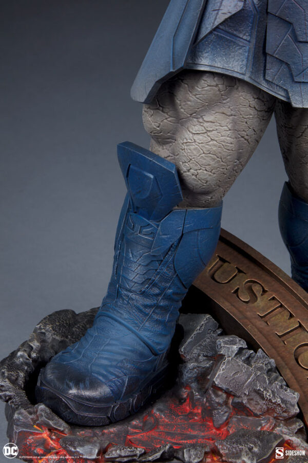 Darkseid DC Comics Maquette from Sideshow Collectibles. Close-up of a collectible superhero statue focusing on the legs with intricate textures, standing on a thematic base labeled 'JUSTICE'