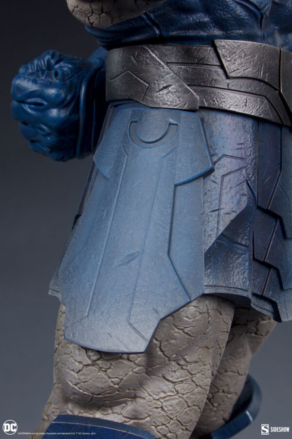 Darkseid DC Comics Maquette from Sideshow Collectibles. Close-up image of a collectible figurine showing detailed texture of a blue fist, grey armored skirt, and a portion of a grey belt.