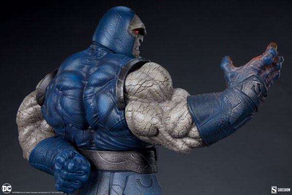 Darkseid DC Comics Maquette from Sideshow Collectibles. A close-up of a high-quality statue of the comic character Darkseid, showcasing intricate textures and details on the costume with a focus on the outstretched hand.