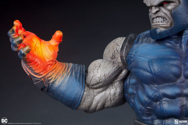 Darkseid DC Comics Maquette from Sideshow Collectibles. A close-up image of a highly detailed Darkseid statue with a focus on the character's hand and face, featuring intricate textures and coloration.