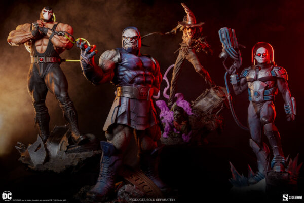 Darkseid DC Comics Maquette from Sideshow Collectibles. Three DC Universe villain figurines - Bane, Darkseid, and a robotic character - posed dramatically with moody lighting and scattered wreckage, highlighting detailed craftsmanship.