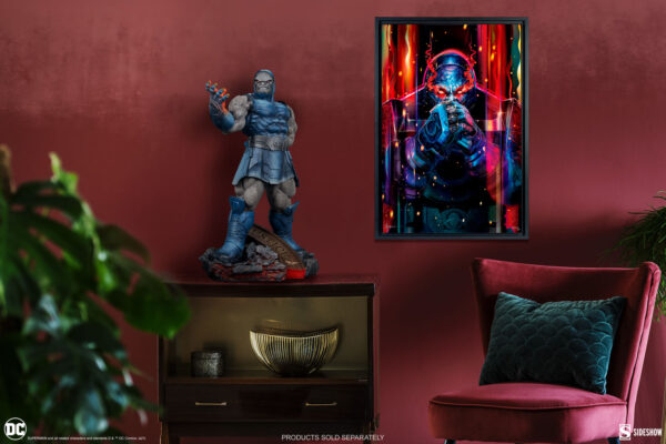 Darkseid DC Comics Maquette from Sideshow Collectibles. A dark superhero statue on a sideboard and a vibrant superhero artwork framed on a burgundy wall in a stylishly decorated room.