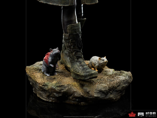 Ratcatcher II BDS Art Scale 1:10 Statue from DC Comics and Iron Studios. A close-up of two comical figurines of rats, one wearing a red cape, beside a person's boot on a textured base against a black background.