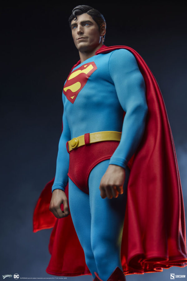 Superman: The Movie Premium Format™ Figure from Sideshow Collectibles and DC Comics. A collectible figure of Superman with traditional blue costume, red cape, and iconic 'S' emblem on the chest standing against a dark background.