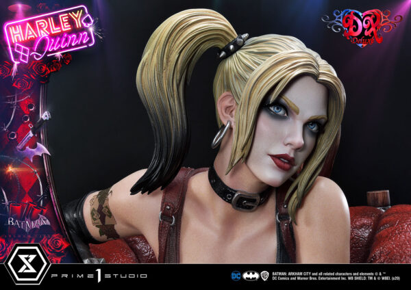 Harley Quinn Deluxe Batman Arkham City Statue Deluxe Version 1:3 Scale Statue from DC Comics and Prime 1 Studio. Close-up of a highly detailed Harley Quinn collectible figure with blue eyes and blonde hair with black tips, set against a dark background with thematic neon signage.