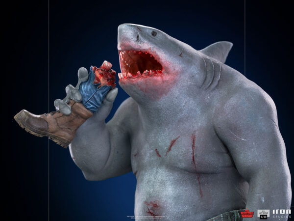 King Shark 1:10 Scale Statue from Iron Studios and DC Comics. A figure with a shark head and humanoid body biting into a boot with visible teeth marks and blood.