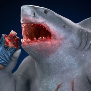 King Shark 1:10 Scale Statue from Iron Studios and DC Comics. A detailed sculpture of a shark eating a bitten ice cream bar, with visible texture and coloring to mimic a realistic appearance.