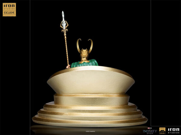 Loki 1:10 Scale Statue by Marvel and Iron Studios. A collectible statue of a character's iconic helmet and scepter, mounted on a golden pedestal, against a black background.