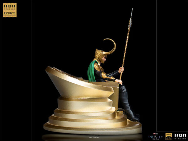 Loki 1:10 Scale Statue by Marvel and Iron Studios. A collectible statue of a character resembling Loki sitting on a throne, holding a spear, against a black background with logos of Iron Studios and the Infinity Saga.