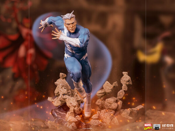 Marvel Quicksilver 1:10 scale statue from Iron Studios. A highly detailed collectible action figure of a superhero with silver hair and blue suit, set against a blurry background with dramatic lighting and floating debris.