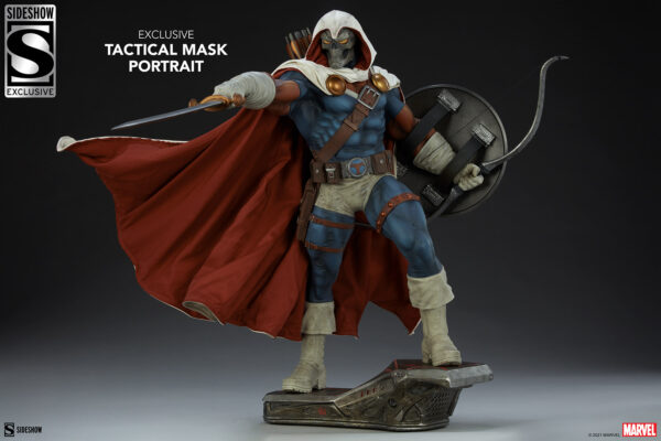 Marvel Taskmaster Premium Format Figure from Sideshow Collectibles. A collectible statue of a character in a tactical mask holding a sword and shield, with a flowing red cape and detailed costume, standing on a themed base.