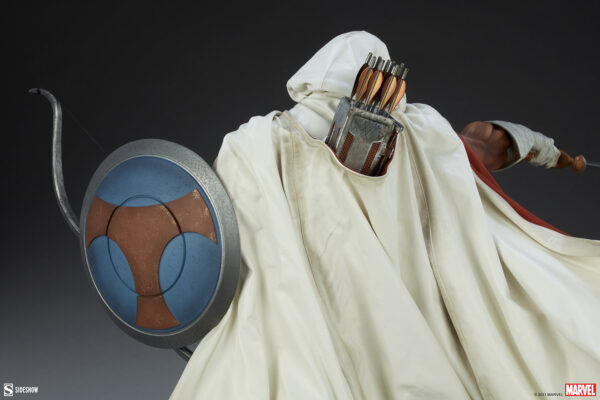 Marvel Taskmaster Premium Format Figure from Sideshow Collectibles. Detailed view of a collectible figure's shield and quiver, showcasing a white cloak and arrows in the background.