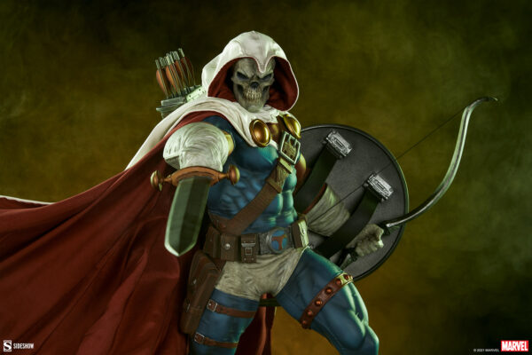 Marvel Taskmaster Premium Format Figure from Sideshow Collectibles. A figure in a skeleton mask and hood with a red cape, carrying a bow, quiver, and shield against a textured yellow background.