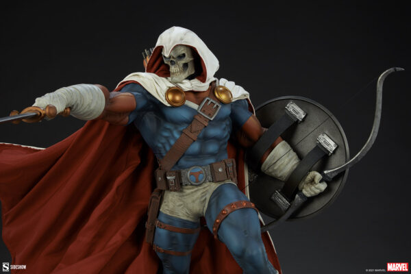 Marvel Taskmaster Premium Format Figure from Sideshow Collectibles. Detailed collectible figure of Taskmaster with skull mask, hood, and shield, set against a dark background.