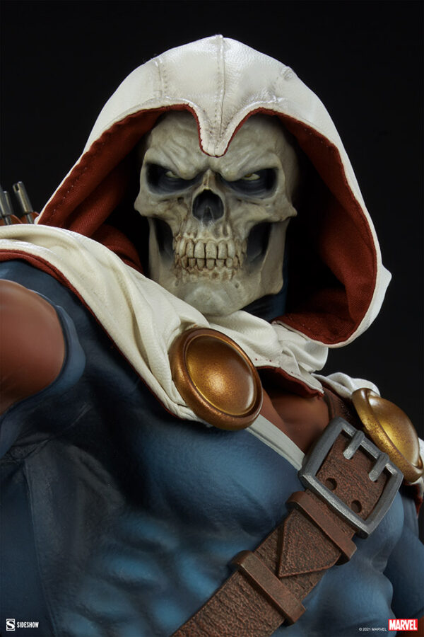 Marvel Taskmaster Premium Format Figure from Sideshow Collectibles. Close-up of a collectible figure with a skull head, wearing a hood and superhero costume, against a black background.