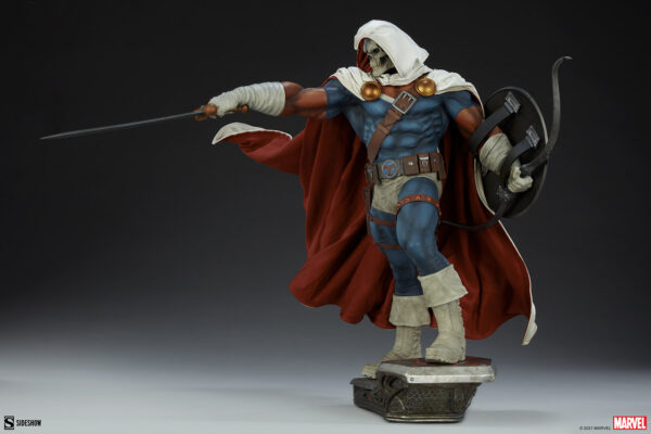 Marvel Taskmaster Premium Format Figure from Sideshow Collectibles. A collectible figure of a hooded character in a white and red costume with dual weapons, poised in an action stance on a themed base.