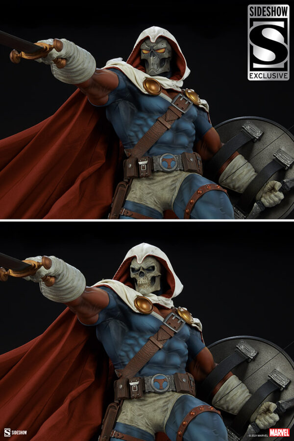 Marvel Taskmaster Premium Format Figure from Sideshow Collectibles. A collectible figure of a fantasy warrior with a skull mask, draped in a red cape, brandishing a sword, and carrying a shield, against a dark background.