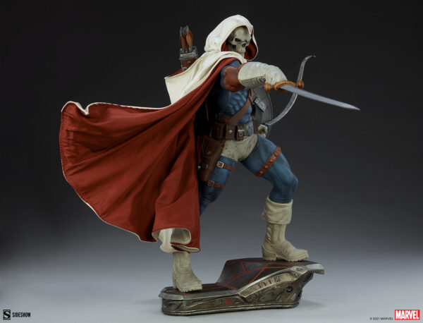 Marvel Taskmaster Premium Format Figure from Sideshow Collectibles. A detailed collectible figure in a white hooded cloak and red cape, wielding a scimitar, standing on a themed base.