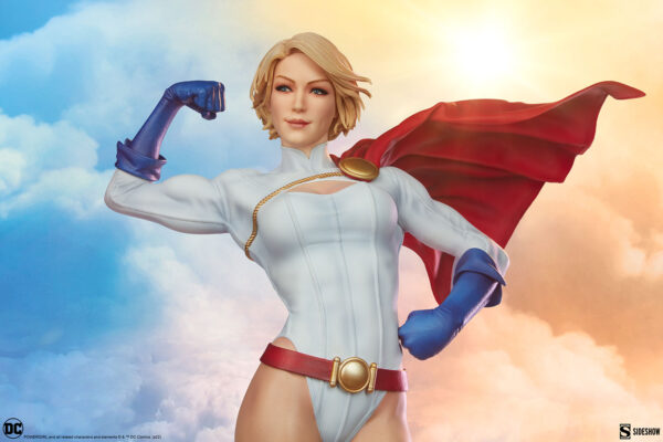 Power Girl Premium Format™ Figure from Sideshow Collectibles. A detailed figure of a female superhero with a white and blue costume and a flowing red cape against a sky background