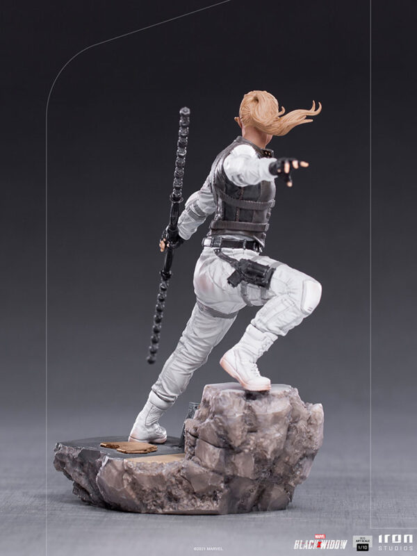 Yelena Belova 1:10 BDS Art Scale Statue from Marvel and Iron Studios. A collectible figure modeled after a superhero character, shown in a dynamic action pose with a weapon in hand, standing on a rocky base.