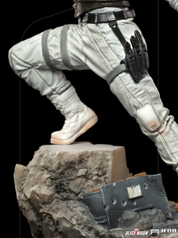 Yelena Belova 1:10 BDS Art Scale Statue from Marvel and Iron Studios. Partial view of a figure wearing white tactical pants and boots, with a holstered weapon on the thigh, ascending a rocky terrain.