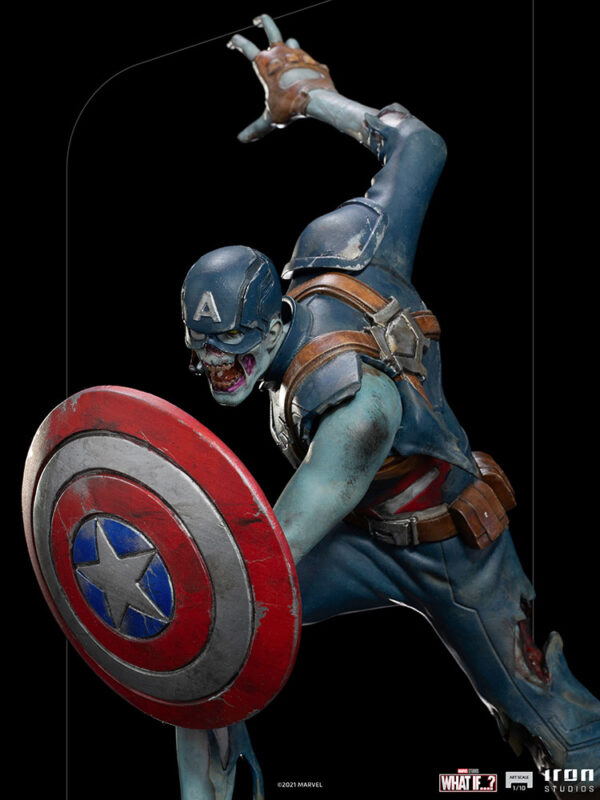 Zombie Captain America Art Scale 1:10 Statue. Zombie Captain America statue in a crouched pose, holding his iconic shield in a defensive stance. His skin appears decayed and blue-toned, with exposed muscles and torn uniform, embodying a grotesque and undead version of the classic Marvel superhero. The statue is set on a rugged, metallic base.