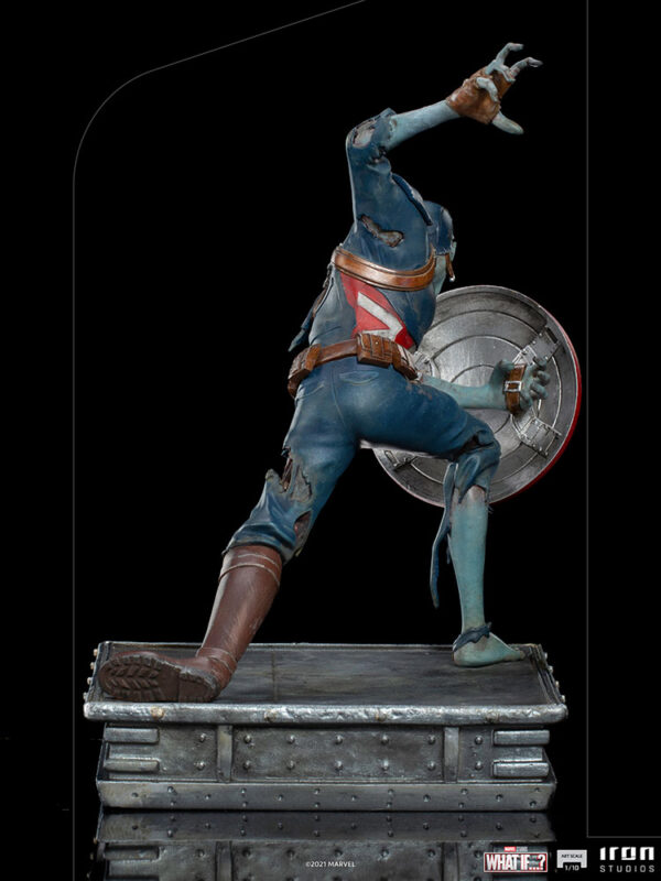 Zombie Captain America Art Scale 1:10 Statue. Zombie Captain America statue in a crouched pose, holding his iconic shield in a defensive stance. His skin appears decayed and blue-toned, with exposed muscles and torn uniform, embodying a grotesque and undead version of the classic Marvel superhero. The statue is set on a rugged, metallic base.