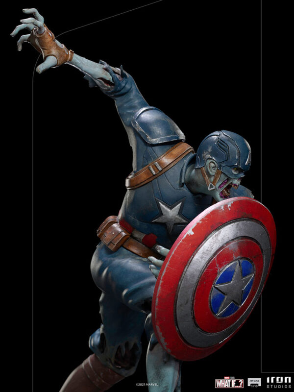 Zombie Captain America Art Scale 1:10 Statue. Zombie Captain America statue in a crouched pose, holding his iconic shield in a defensive stance. His skin appears decayed and blue-toned, with exposed muscles and torn uniform, embodying a grotesque and undead version of the classic Marvel superhero. The statue is set on a rugged, metallic base.