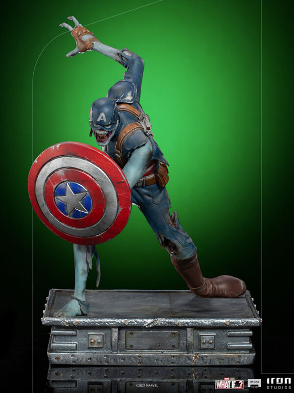 Zombie Captain America Art Scale 1:10 Statue. Zombie Captain America statue in a crouched pose, holding his iconic shield in a defensive stance. His skin appears decayed and blue-toned, with exposed muscles and torn uniform, embodying a grotesque and undead version of the classic Marvel superhero. The statue is set on a rugged, metallic base.