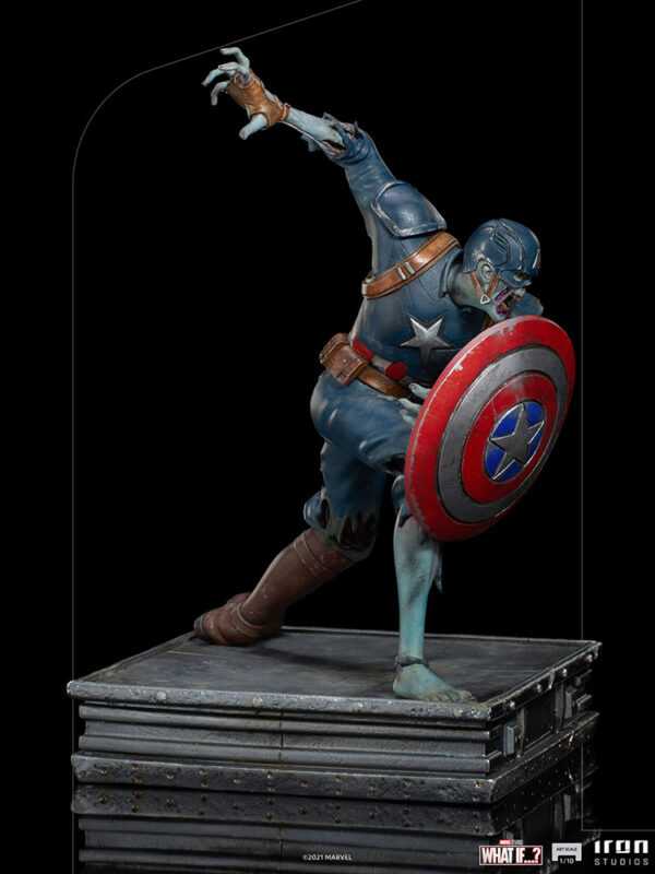 Zombie Captain America Art Scale 1:10 Statue. Zombie Captain America statue in a crouched pose, holding his iconic shield in a defensive stance. His skin appears decayed and blue-toned, with exposed muscles and torn uniform, embodying a grotesque and undead version of the classic Marvel superhero. The statue is set on a rugged, metallic base.