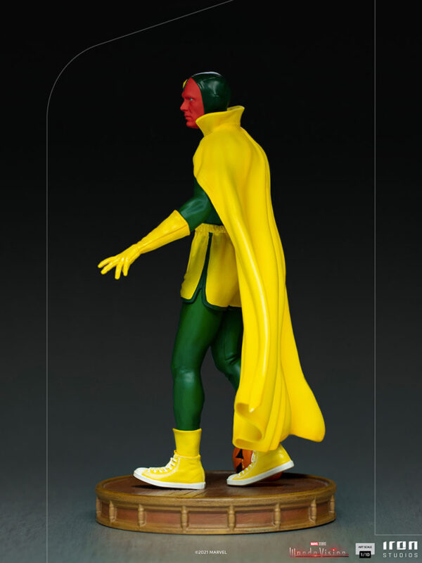 Vision Halloween Version WandaVision Art Scale 1:10 Statue from Marvel and Iron Studios. A collectible statue of a classic superhero with a green and yellow costume and flowing yellow cape, standing on a wooden base.