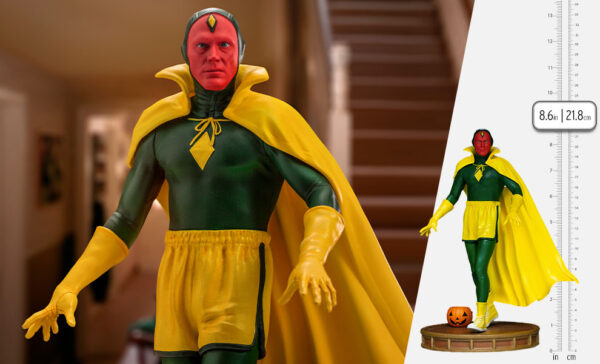 Vision Halloween Version WandaVision Art Scale 1:10 Statue from Marvel and Iron Studios. A detailed action figure of a comic book character in a green and yellow costume is displayed in a home setting, with a size comparison chart on the right.