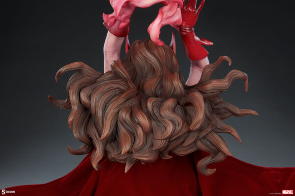 Marvel Scarlet Witch Premium Format™ Figure from Sideshow Collectibles, 2021. Close-up of a detailed figurine showing the dynamic hair and flowing red cape of a superhero, with hands poised in an action gesture.